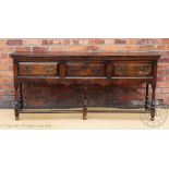 An oak dresser base, 18th century and later timbers, with three drawers,