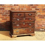 A George III oak and mahogany cross banded chest, with two short and three long drawers,