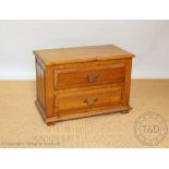 A modern oak chest of small proportions, with two drawers, on block feet,