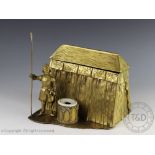 A figural brass desk stand modelled as a 17th century soldier stood besides an inkwell and tour