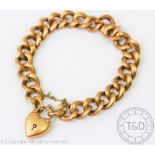 A 9ct yellow gold bracelet with attached heart shaped padlock clasp,