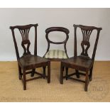 A pair of George III country oak dining chairs, with pierced splats and solid seats,