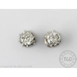 A pair of diamond solitaire earrings, each set with a single old cut diamond (of approx 0.