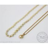 An imitation pearl set pendant with an attached fine 9ct gold chain, gross weight 7.