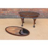A walnut oval occasional table, with claw and ball feet,