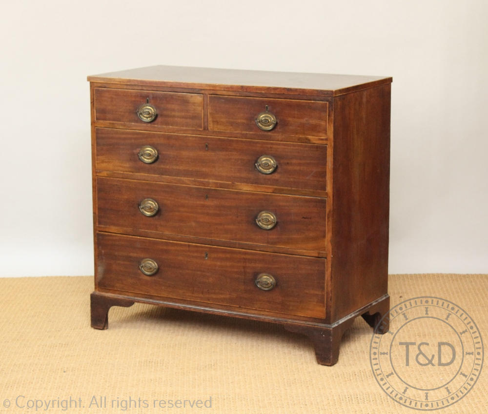 A late George III mahogany chest, with two short and three graduated long drawers, on bracket feet,