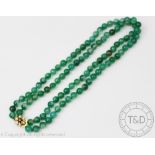 A green banded agate bead necklace, designed as a two row uniform polished bead necklace,