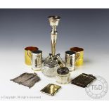 A selection of silver and silver plated items to include; a silver candlestick, A T Cannon Ltd,