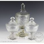 A pair of 19th century cut glass pedestal cups and cover, each with faceted detailing,