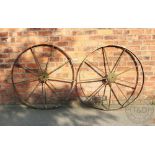 A pair of cast iron cart wheels, nine spoke,