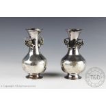 A pair of chinese white metal prunus vases,