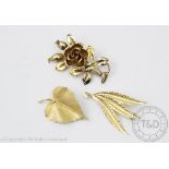 Three 9ct yellow gold brooches, to include; a leaf form brooch,