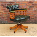 A green button back leather office swivel desk chair,