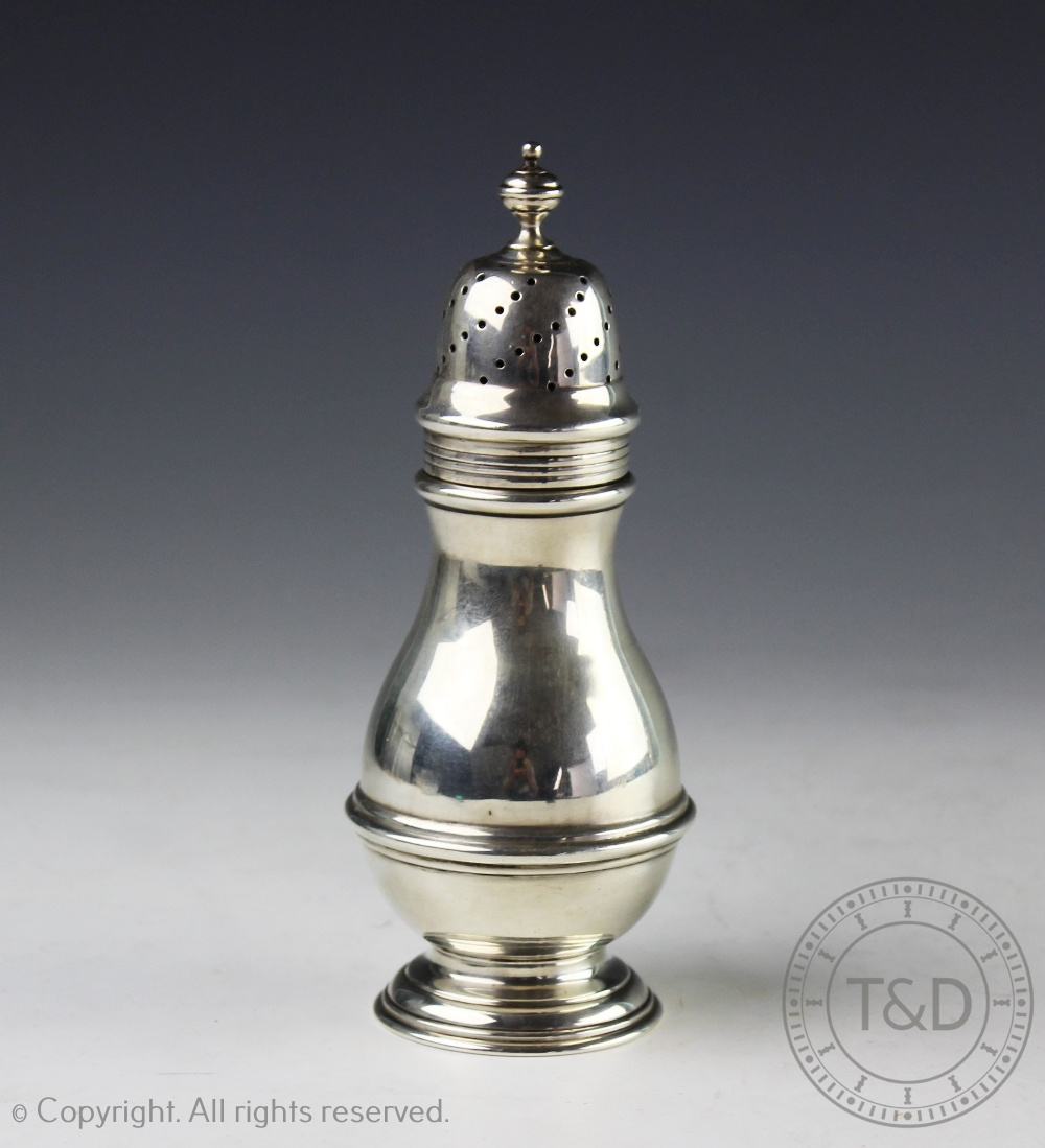 An Edwardian silver sugar caster, London 1903, of baluster form with reeded detail,