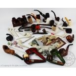 An assorted collection of smoking pipes to include silver mounted examples, clay examples,