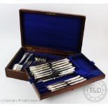 A canteen of silver and white metal cutlery comprising; six fiddle pattern table forks,