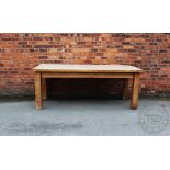 A modern light oak farmhouse type kitchen dining table, the three plank top with cleated ends,