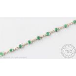 An emerald and diamond line bracelet,