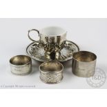 A Victorian silver tea cup and saucer, London 1896, the cup with milk glass liner,