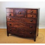 An early 19th century mahogany chest, with four short and one deep drawer above three long drawers,