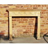 An Adam style carved and moulded pine fire surround, decorated with bow tied swags,