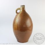 A large German stoneware salt glazed flagon, 18th century, of ovoid shape with loop handle,