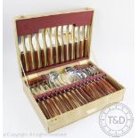 A 1970's Glosswood cased canteen containing; twelve knives and forks, six spoons, six teaspoons,