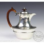 An Edwardian silver tea pot, London, 1910, with gadrooned detailing and bakelite handle,