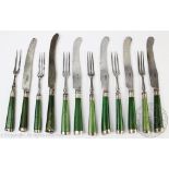A set of four pairs of 18th century knives and forks with green ivory handles,