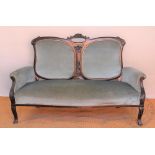 An Edwardian stained beech salon sofa, with blue upholstery and floral scroll frame, on scroll legs,