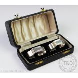 A cased pair of silver Art Deco napkin rings, E Silver & Co, London 1945,