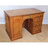 A late Victorian pitch pine desk,