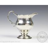 An early George III silver cream jug, NS&AN, London 1764,