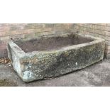 A 19th century carved stone garden trough, with bow front and dressed sides,