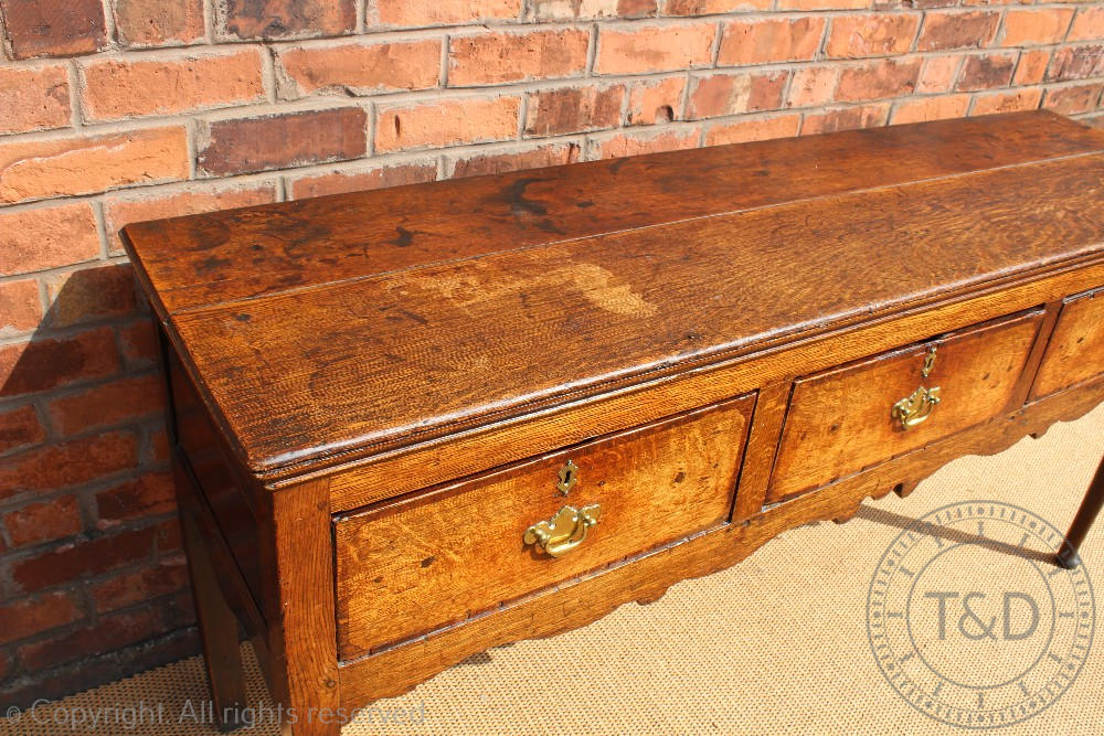 An 18th century Shropshire oak dresser base, with three drawers above a serpentine apron, - Image 4 of 4