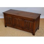 A 1930's oak coffer, with linen fold detailing,