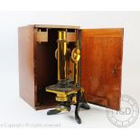 A late 19th century lacquered brass monocular microscope by Henry Crouch, in mahogany case,