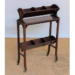 An Edwardian mahogany book trough, two tier, on slender square legs,