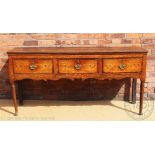 An 18th century Shropshire oak dresser base, with three drawers above a serpentine apron,