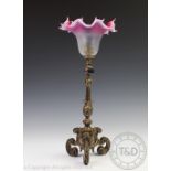 An Edwardian Silver plated lamp base, of rococo style with scroll and leaf cast detailing,
