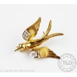 A 9ct gold and diamond set bird brooch, modelled in flight and with diamond set wings, 2.1gms, 2.