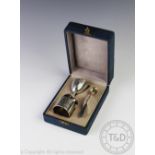 A cased '800' standard silver Christening set, comprising; egg cup, spoon and napkin ring,