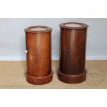 Two Victorian mahogany cylindrical bedside cupboards, each with inset marble tops, on plinth base,