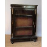 A Victorian ebonised pier cabinet, with glazed door enclosing shelves,