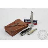 A tan leather fisherman's pouch, enclosing a Smith & Wesson fisherman's type knife,