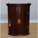 A George III style inlaid bow front corner cabinet,