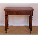 A Victorian mahogany tea table, with hinged top, on turned legs,