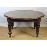 A Victorian mahogany dining table, the rounded top with a moulded edge, on gadrooned,