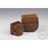 Two early tan leather reel cases, the larger possibly to take a 4 & 1/4 inch reel,