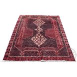 An Afshar wool rug, worked with three gulls against a Paisley inspired wool ground,